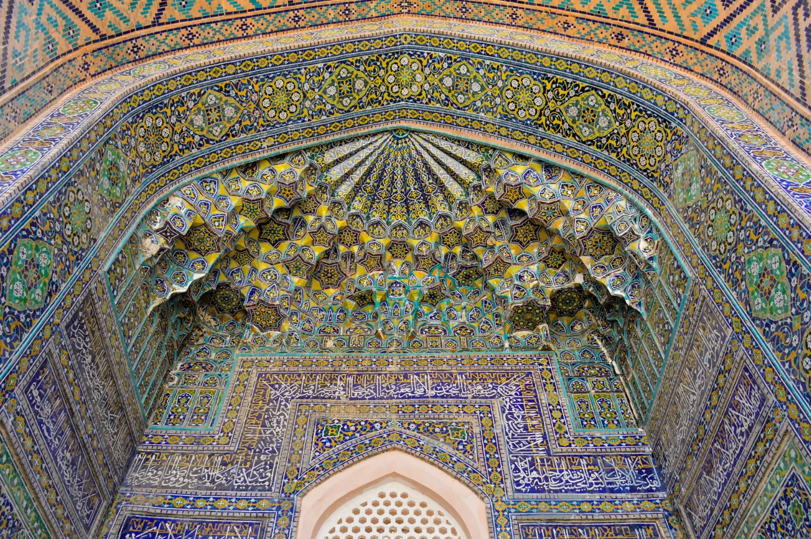 Vast marble courtyard inlaid with floral patterns at the Sheikh Zayed Grand Mosque, Abu Dhabi, United Arab Emirates