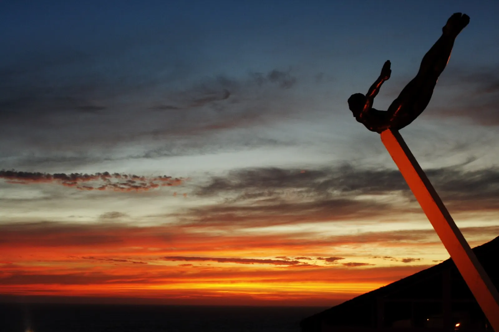 A cliff diver leaping from the rocks at La Quebrada in Acapulco, Guerrero