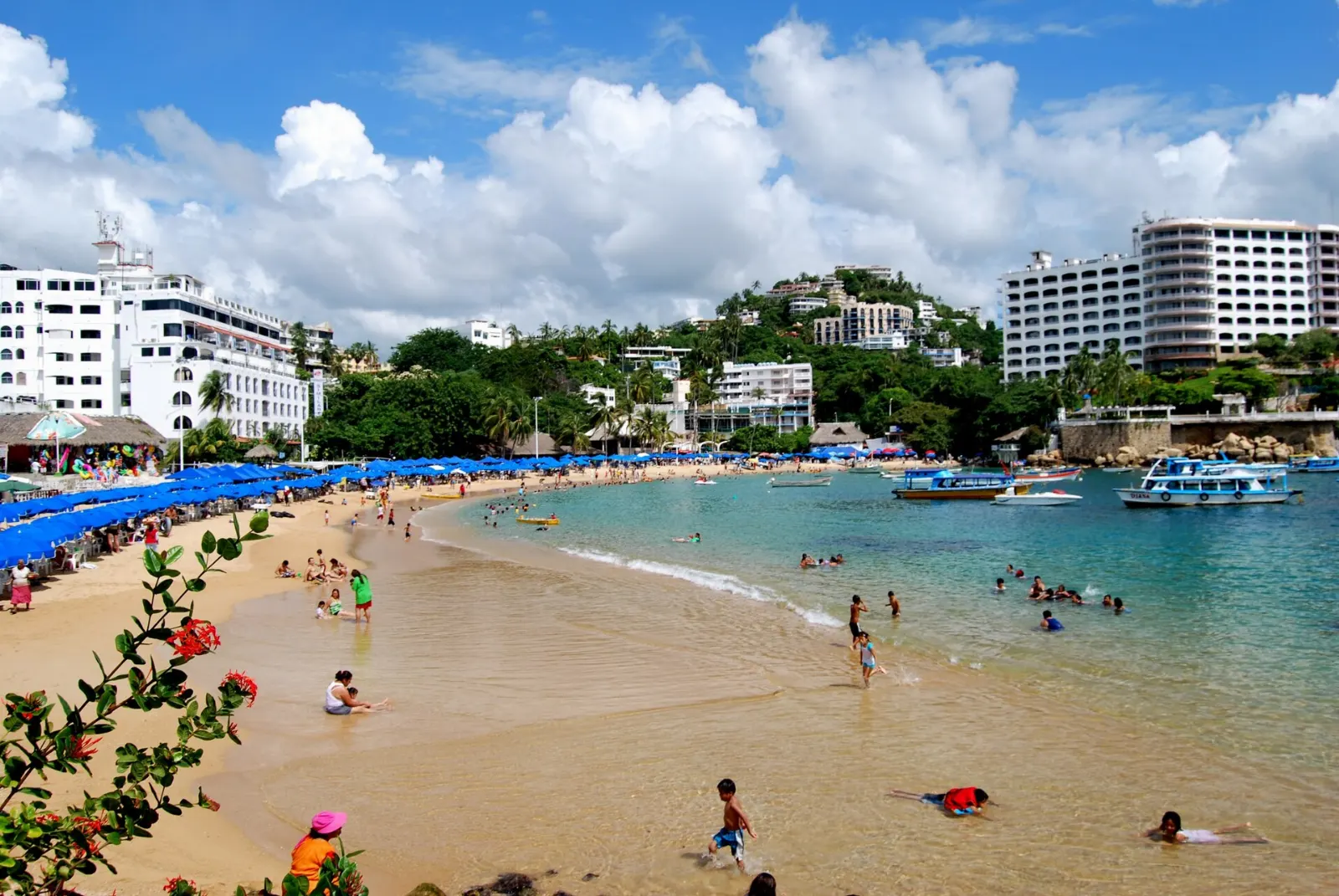 Bathers and boats at Caleta Beach in Acapulco, Guerrero