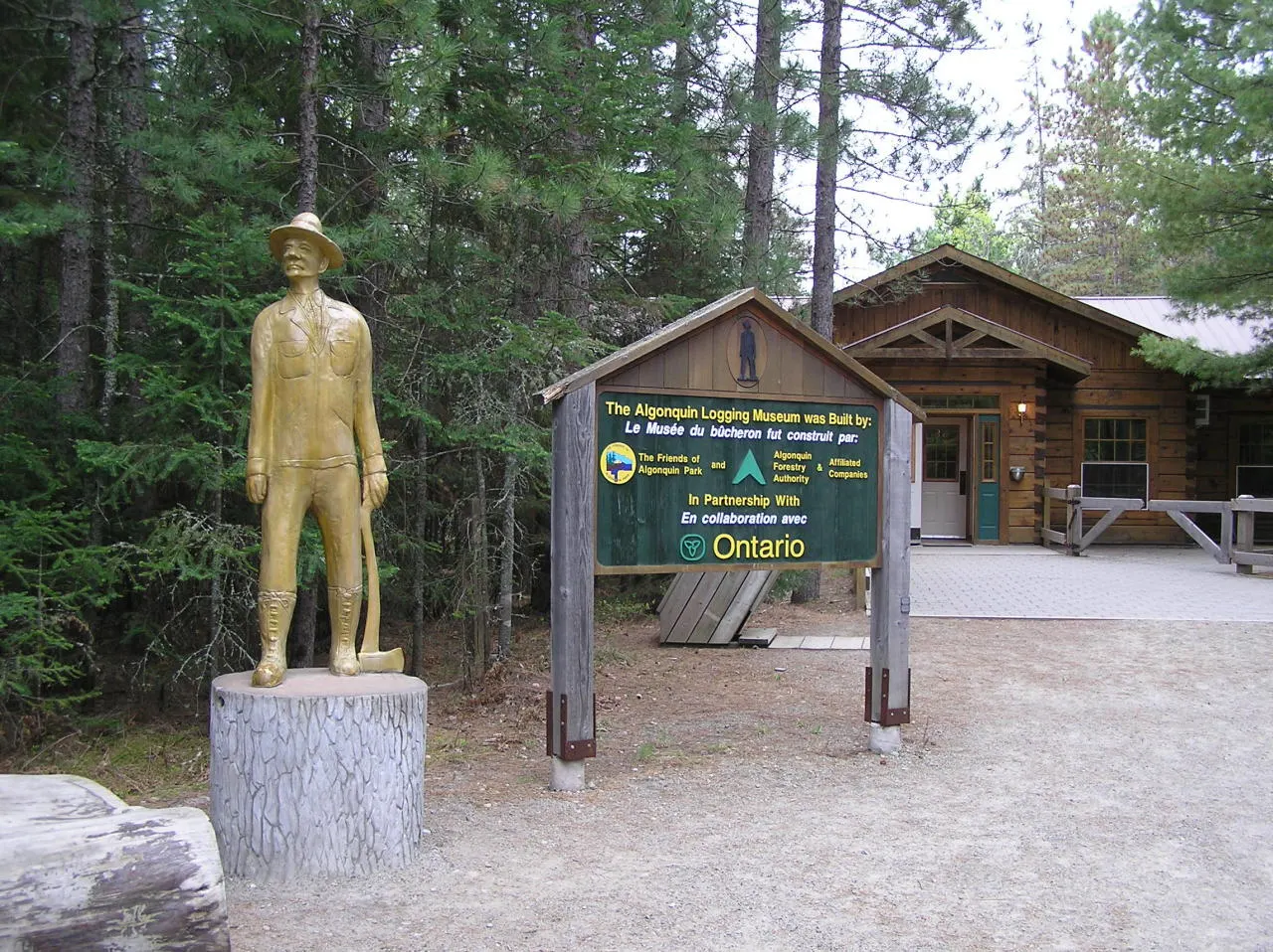 Historic logging equipment displayed outdoors along a forest path, Algonquin Provincial Park, Ontario