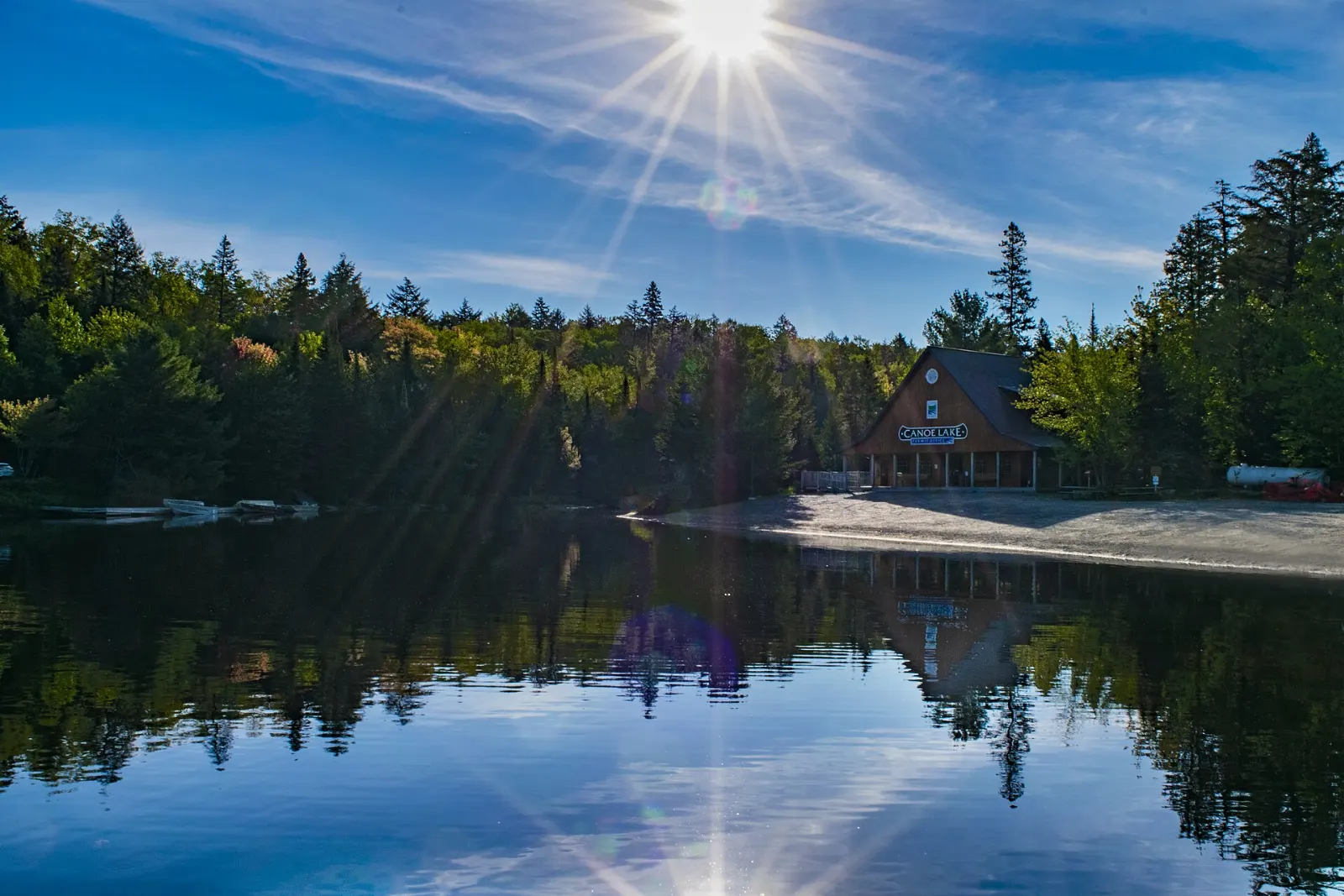 Canoes on Canoe Lake with a forested shoreline, Algonquin Provincial Park, Ontario