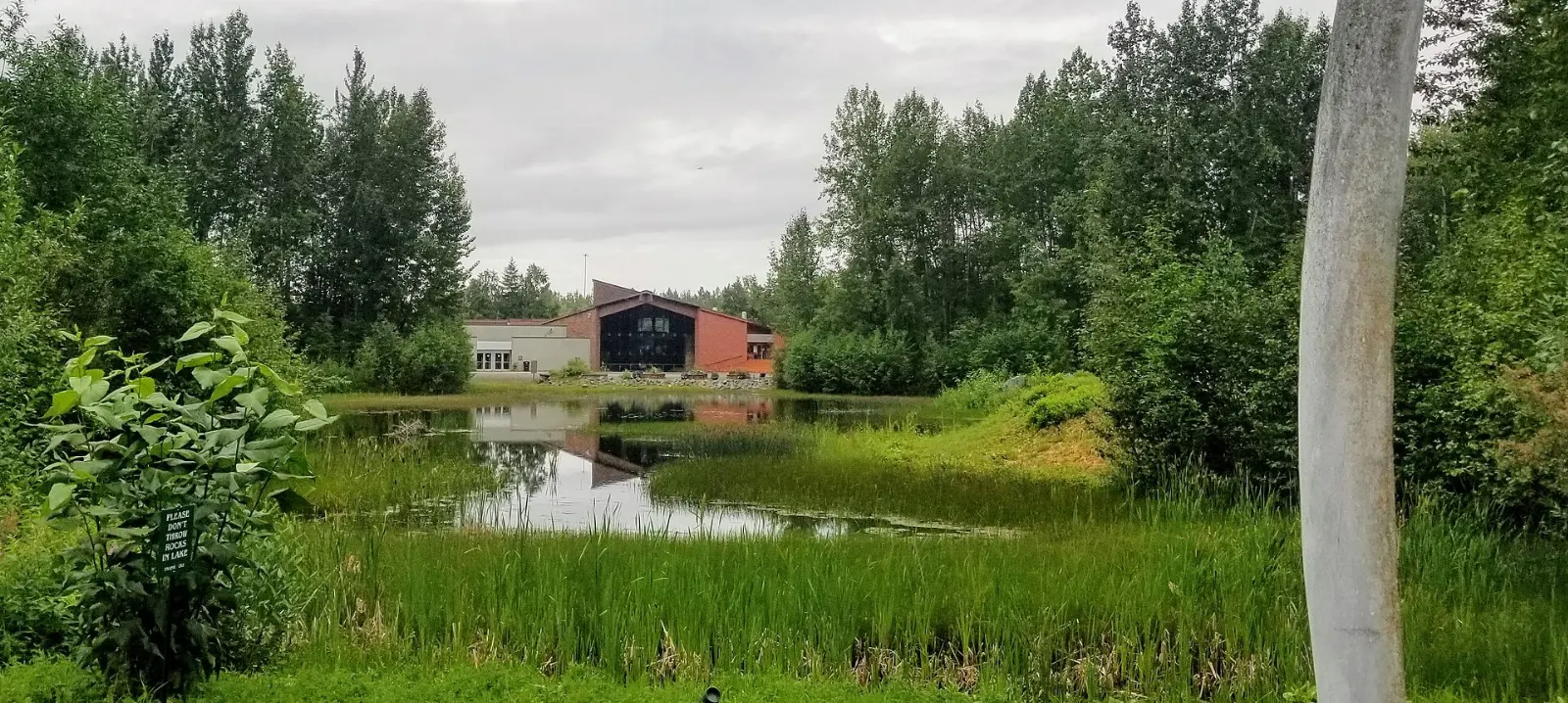 A traditional Alaska Native dwelling beside Lake Tiulana at the Alaska Native Heritage Center, Anchorage, Alaska