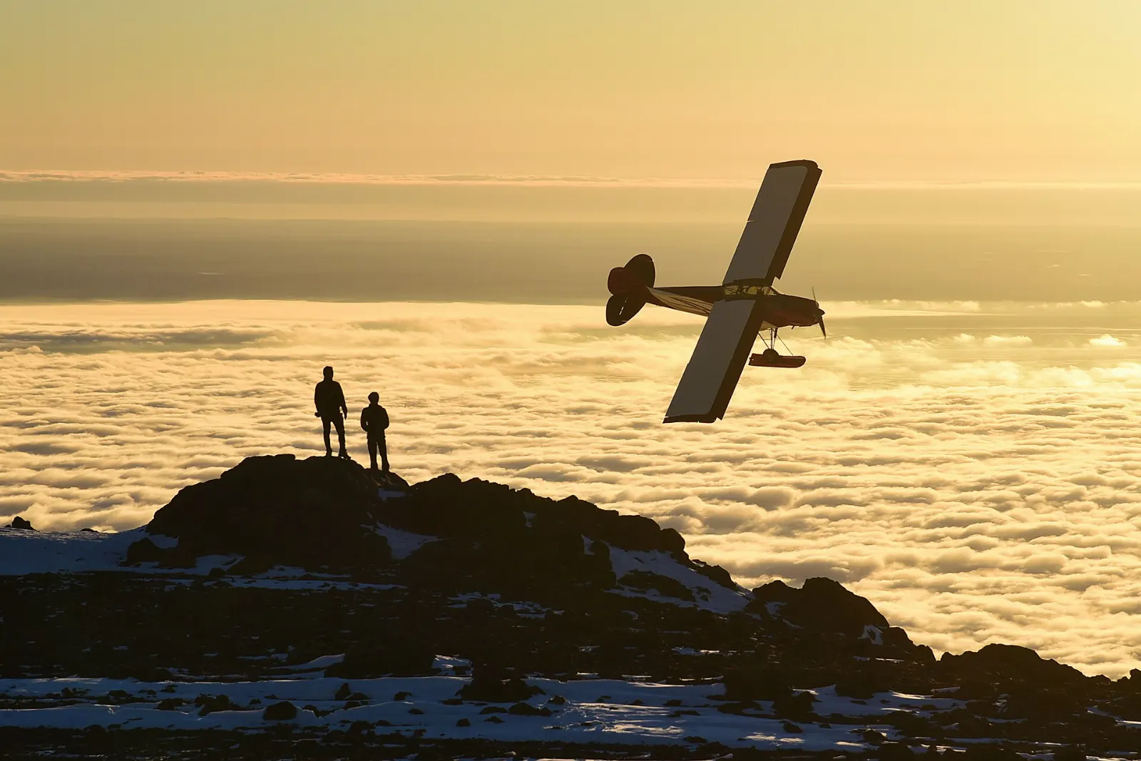 Hikers on a rocky ridge on Flattop Mountain overlooking Anchorage and Cook Inlet, Alaska