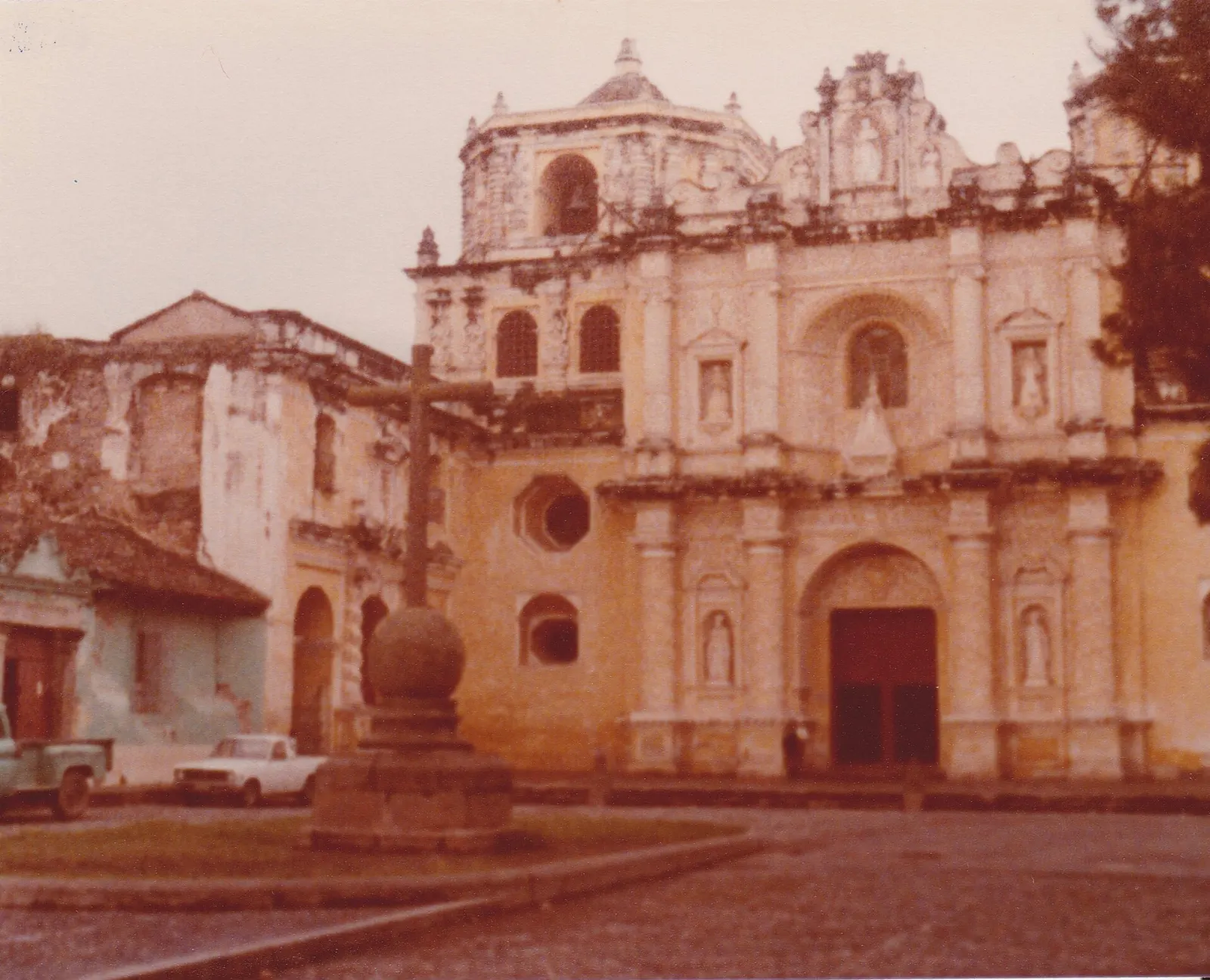 The yellow and white stucco facade of La Merced church in Antigua, Guatemala