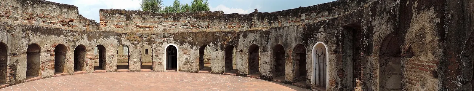 Stone arches and a circular cloister in the ruins of the Capuchinas convent, Antigua, Guatemala
