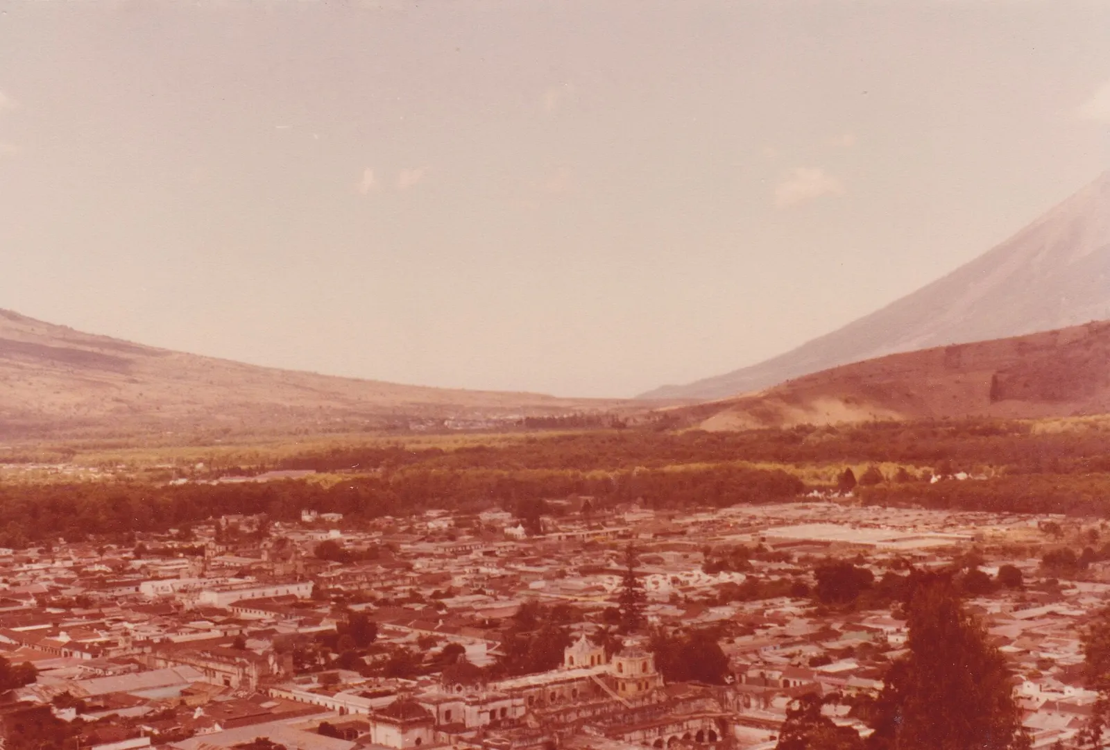 View over the grid of Antigua's rooftops to Volcán de Agua from the Cerro de la Cruz cross, Guatemala