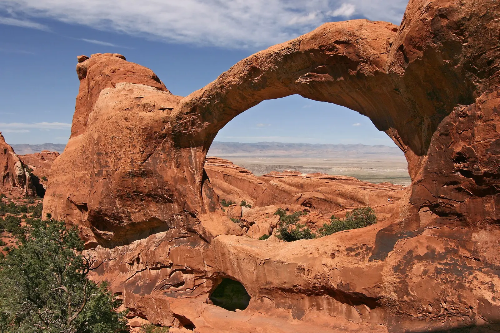 Two massive arches sharing a common base beneath a blue sky, Arches National Park, Utah