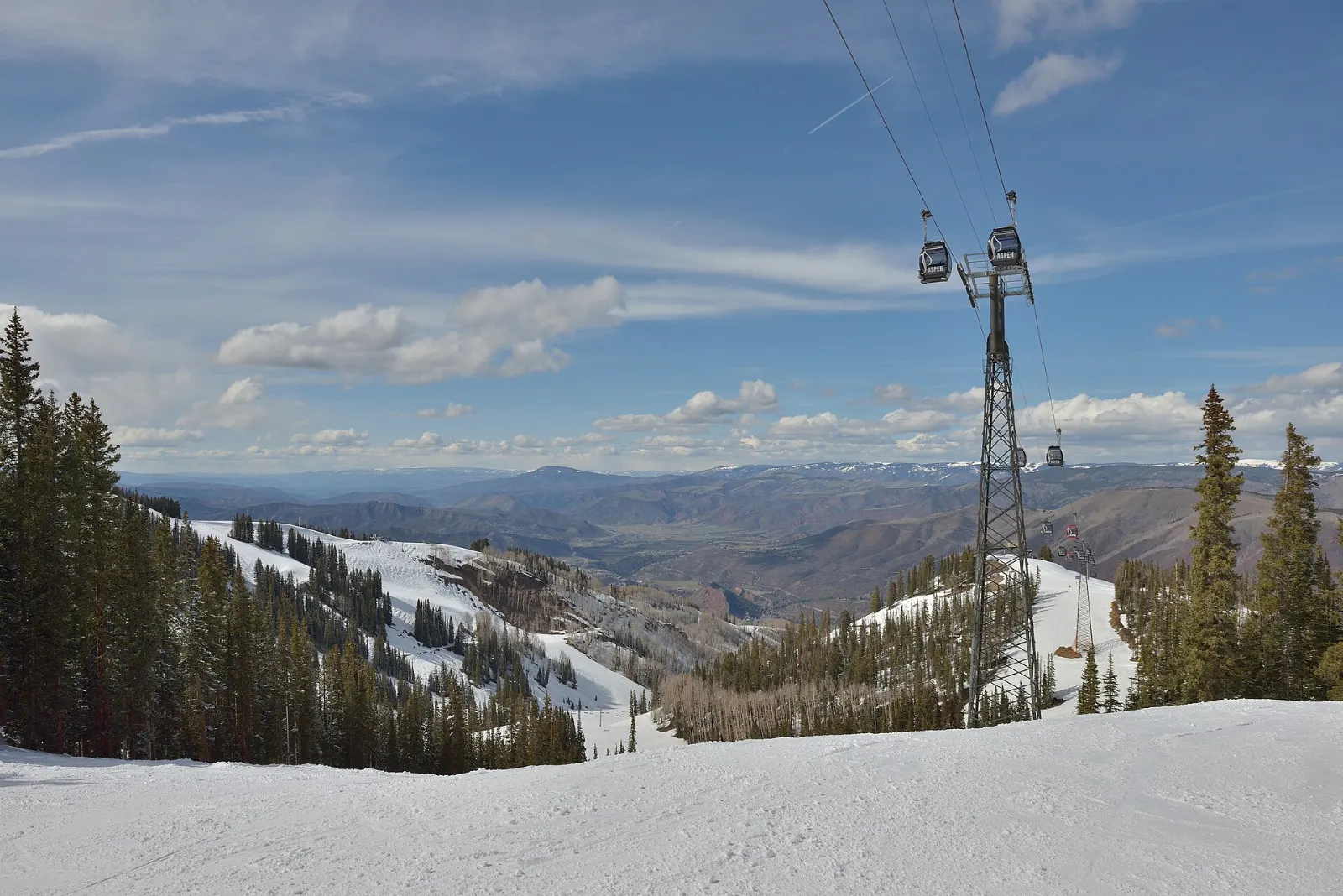 Gondola cabins rising up the slopes of Aspen Mountain above town, Colorado