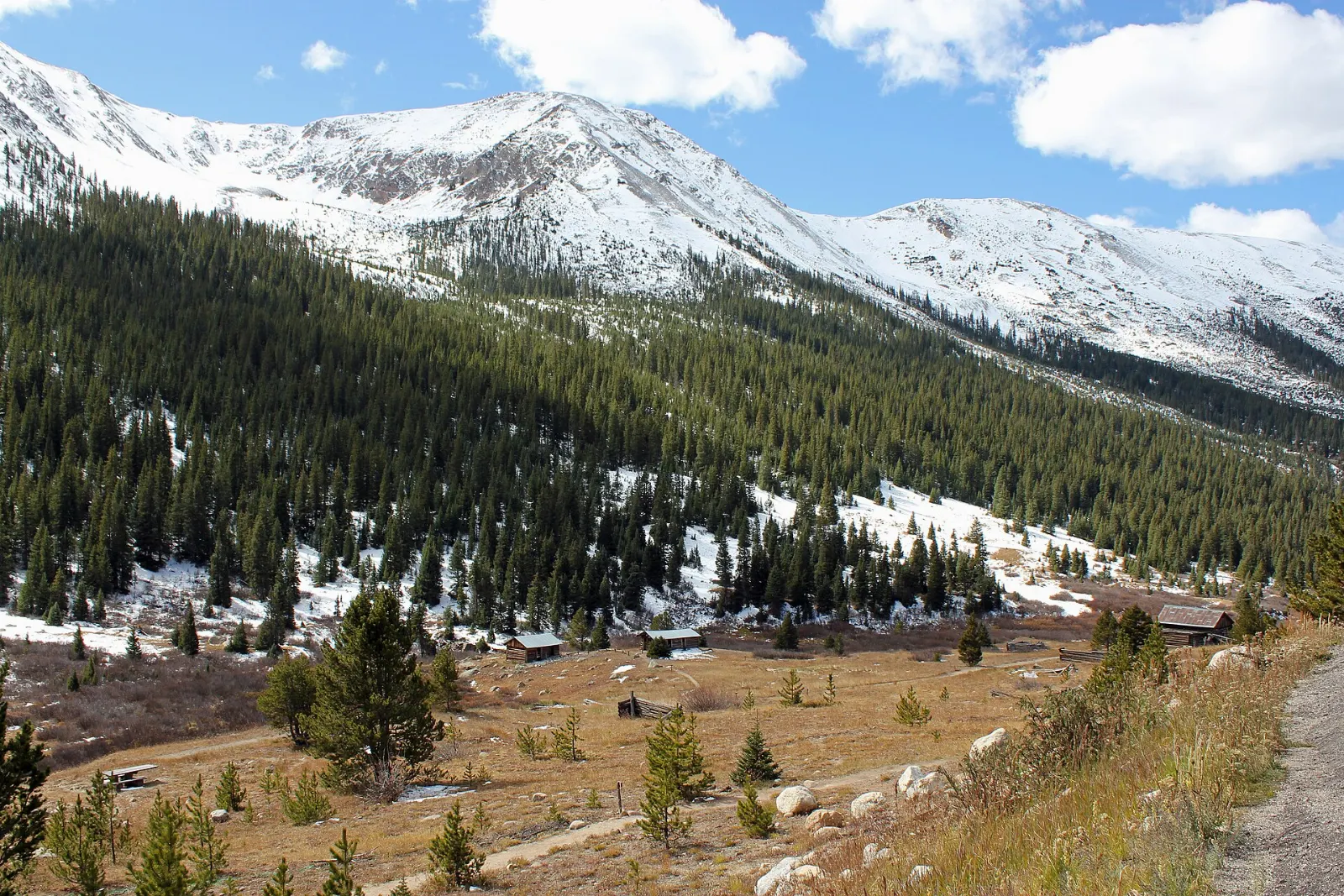 Weathered log cabins of the Independence ghost town in a high mountain valley, Aspen, Colorado