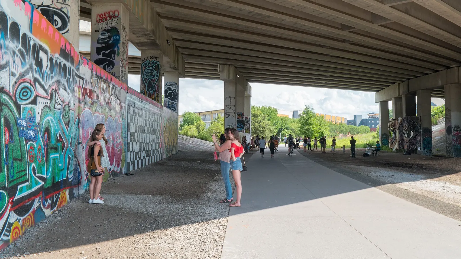 Walkers and cyclists on the Eastside Trail of the Atlanta BeltLine lined with murals, Georgia
