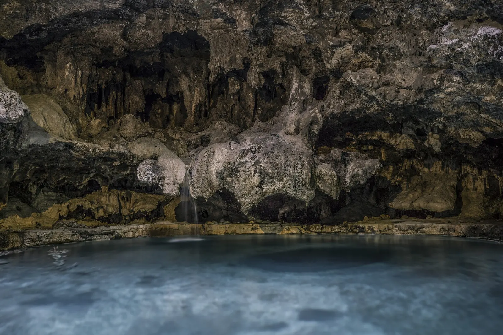 Historic stone bathhouse and warm spring pool at the Cave and Basin site, Banff National Park, Canada