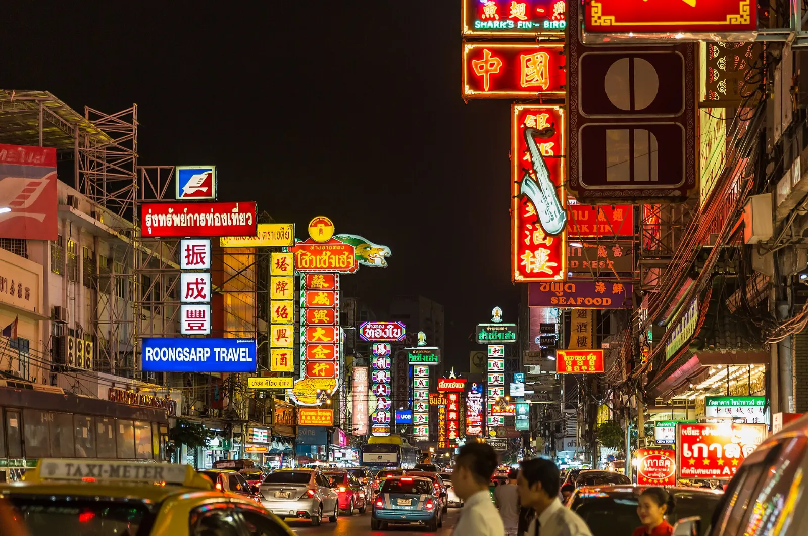 Neon signs in Chinese and Thai lighting up Yaowarat Road at night, Bangkok, Thailand