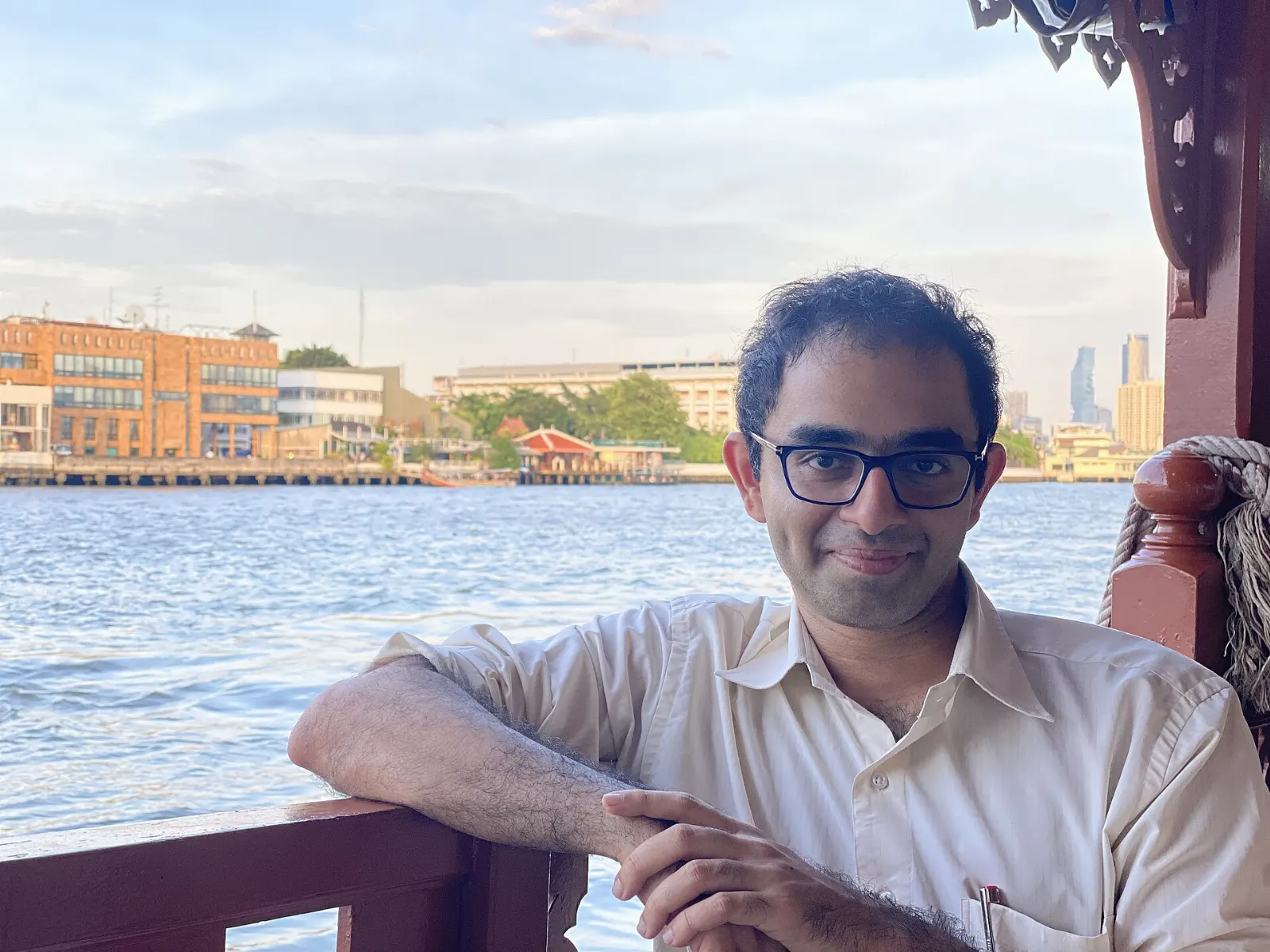 A Chao Phraya Express boat pulling into a river pier in Bangkok, Thailand