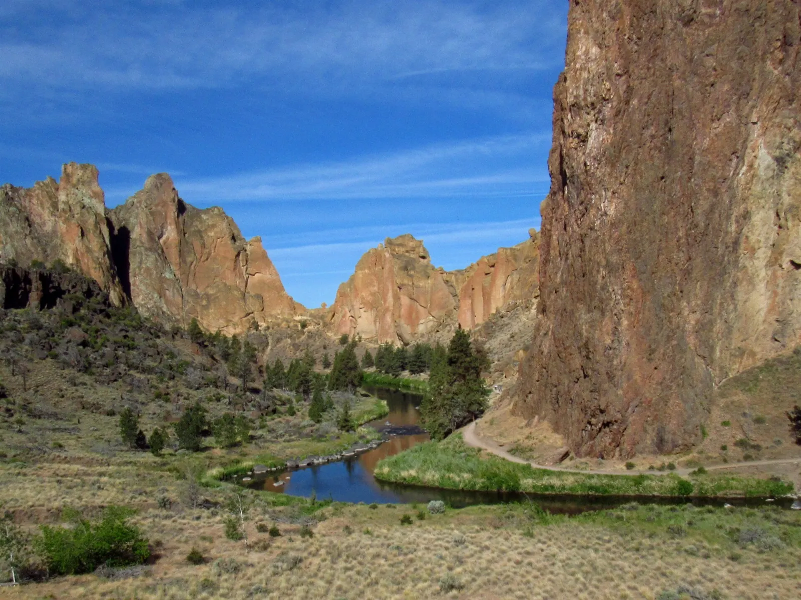 Smith Rock's orange tuff cliffs above a bend in the Crooked River, Oregon