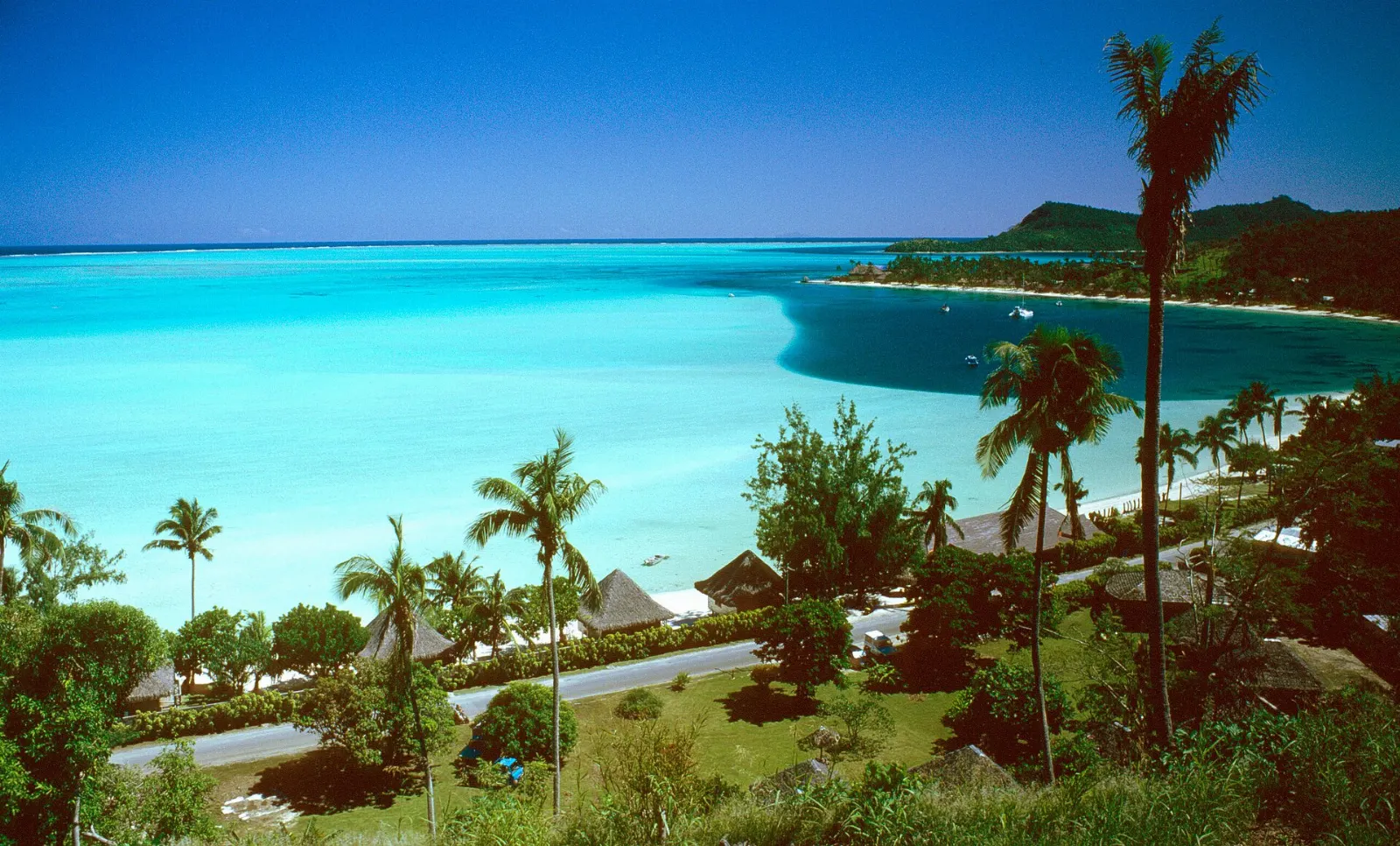White sand and shallow turquoise water at Matira Beach on the southern tip of Bora Bora, French Polynesia