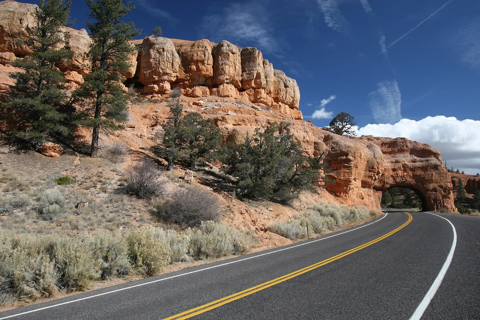 Road tunnel cut through red rock arches on Scenic Byway 12, Bryce Canyon National Park, Utah