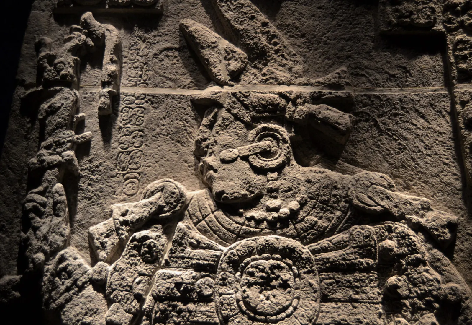 Carved stone stelae standing in front of a temple at Calakmul, Campeche