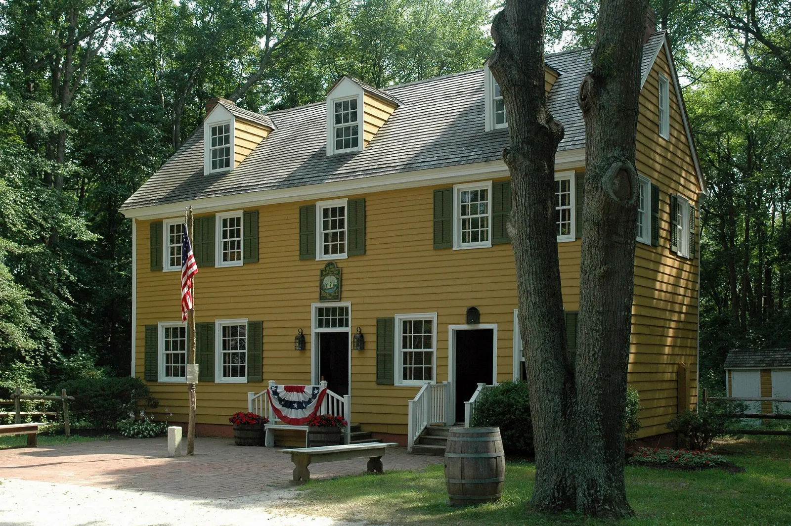 Historic wooden buildings along a shaded lane at Historic Cold Spring Village, Cape May, New Jersey