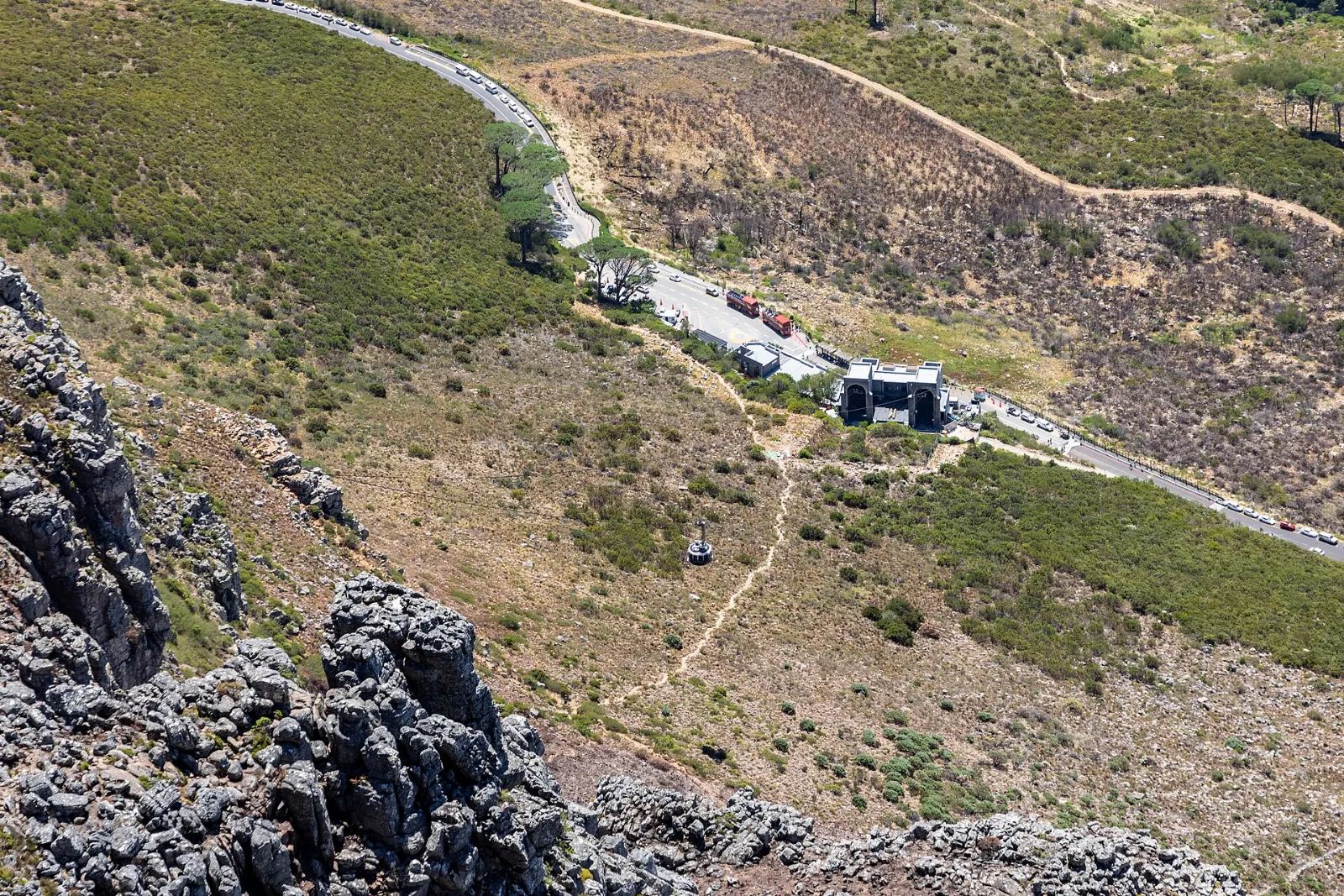 A round cable car climbing toward the cliffs of Table Mountain, Cape Town, South Africa