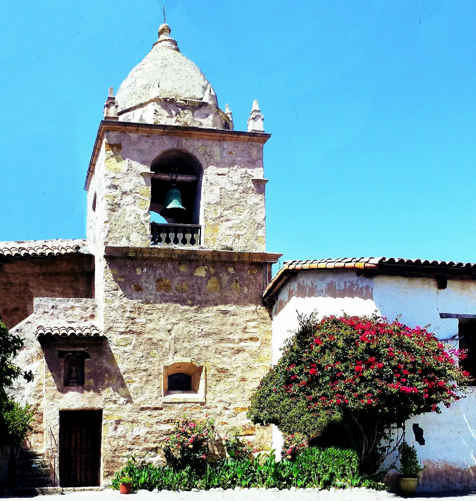 Stone facade and bell tower of the Carmel Mission basilica, Carmel-by-the-Sea, California