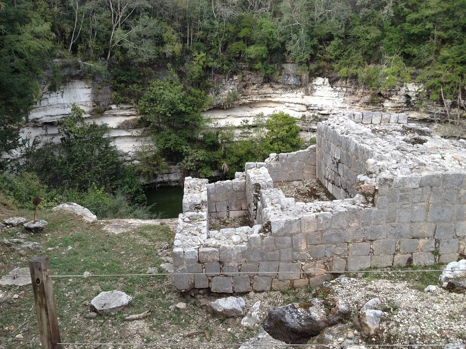 The Sacred Cenote sinkhole surrounded by jungle at Chichén Itzá, Yucatán