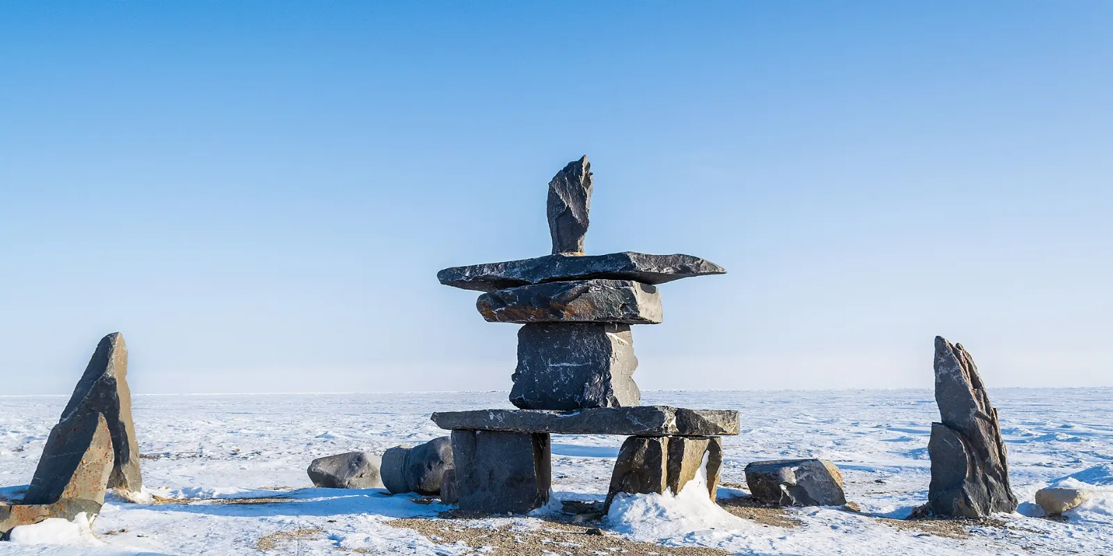 A stone inukshuk standing on the shore of Hudson Bay at Churchill, Manitoba