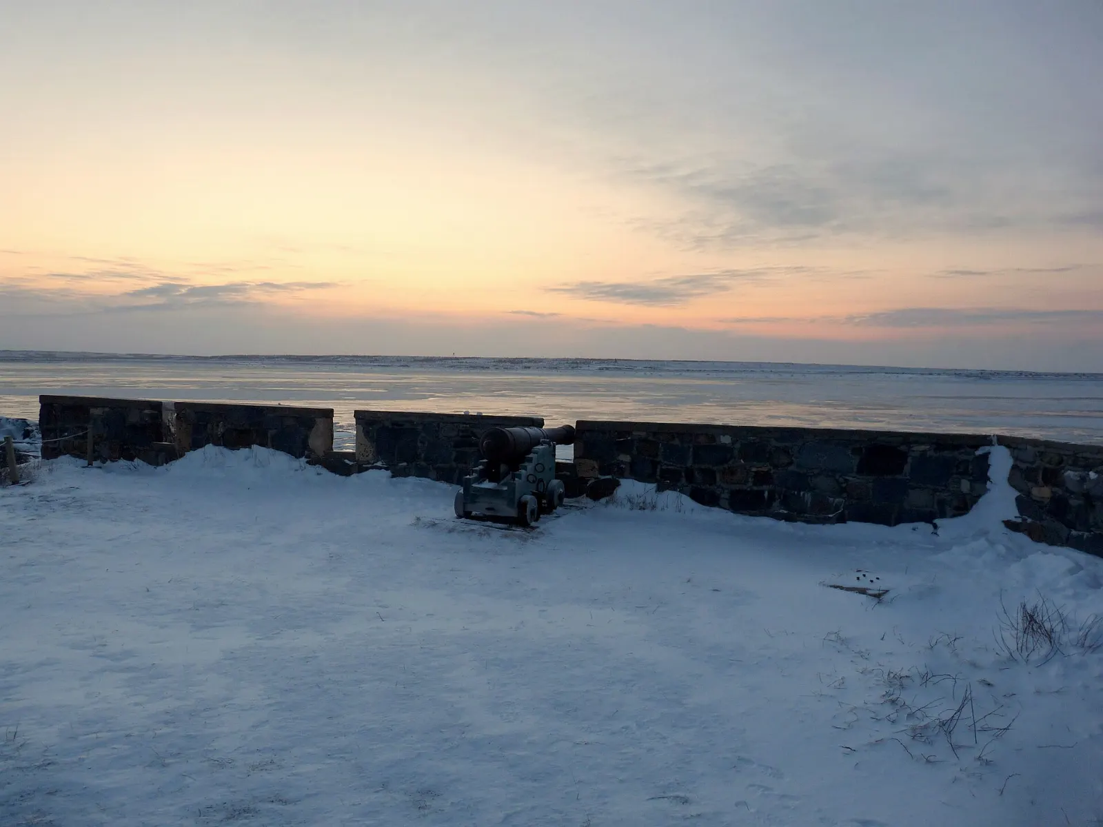 Rocky tundra and a reconstructed cannon battery at Cape Merry overlooking the Churchill River, Manitoba