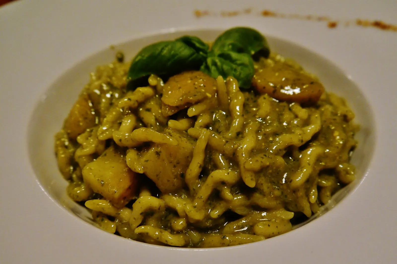 Plate of trofie pasta coated in green basil pesto, Cinque Terre, Italy