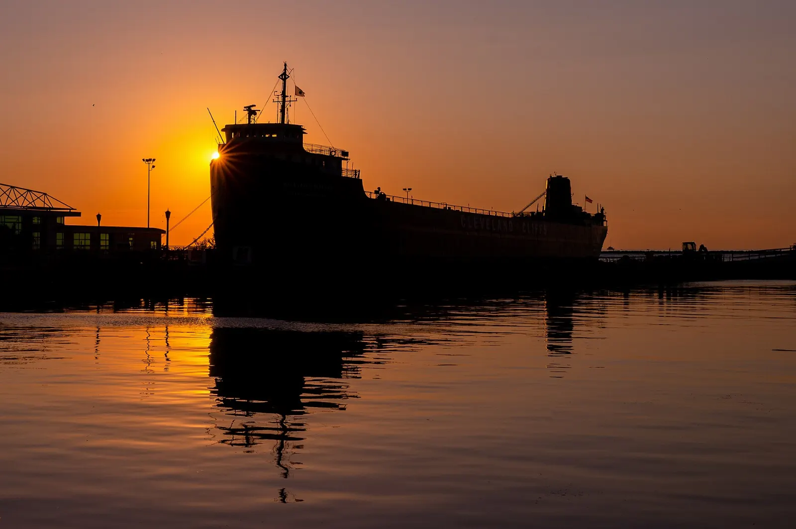 The red and black hull of the museum ship William G. Mather moored on the Cleveland waterfront, Ohio