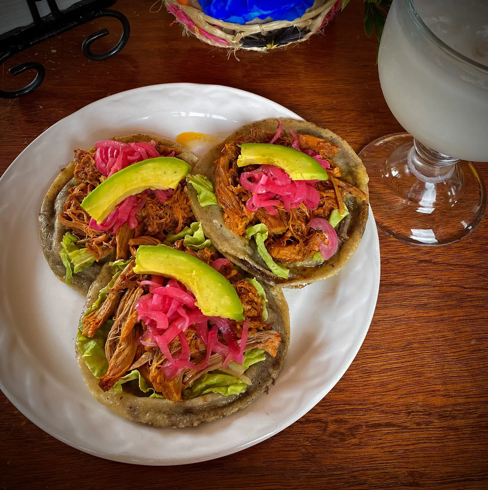 A plate of panuchos topped with chicken and pickled onion, Cobá, Quintana Roo