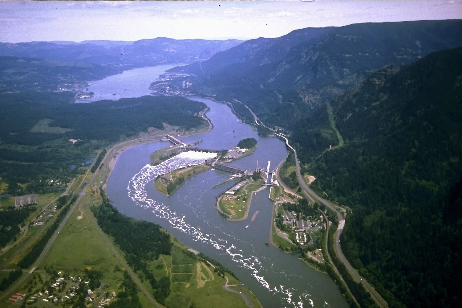 Bonneville Dam stretching across the Columbia River with forested hills behind, Columbia River Gorge, Oregon