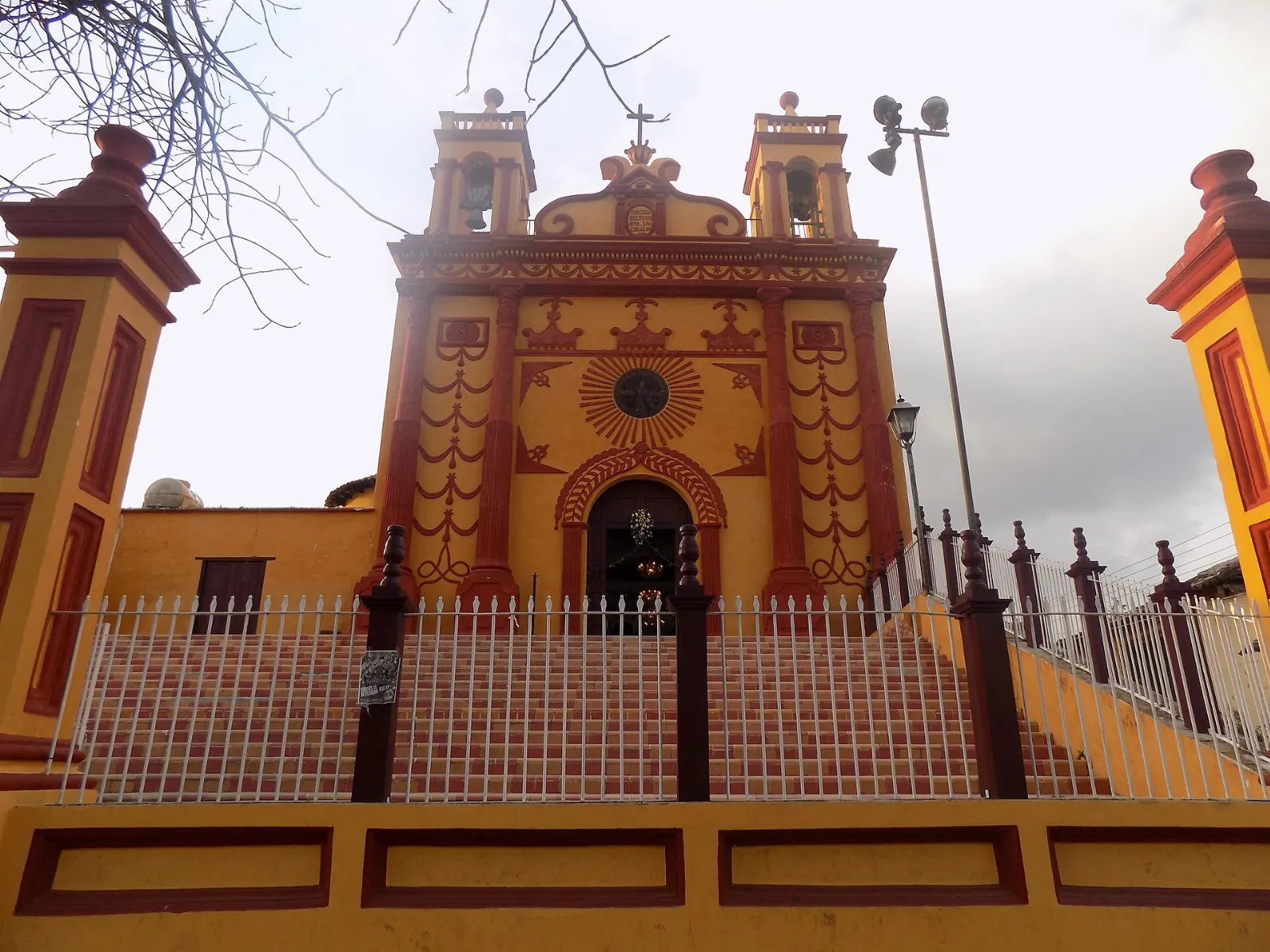 Orange and red façade of the Templo de San Caralampio in Comitán, Chiapas