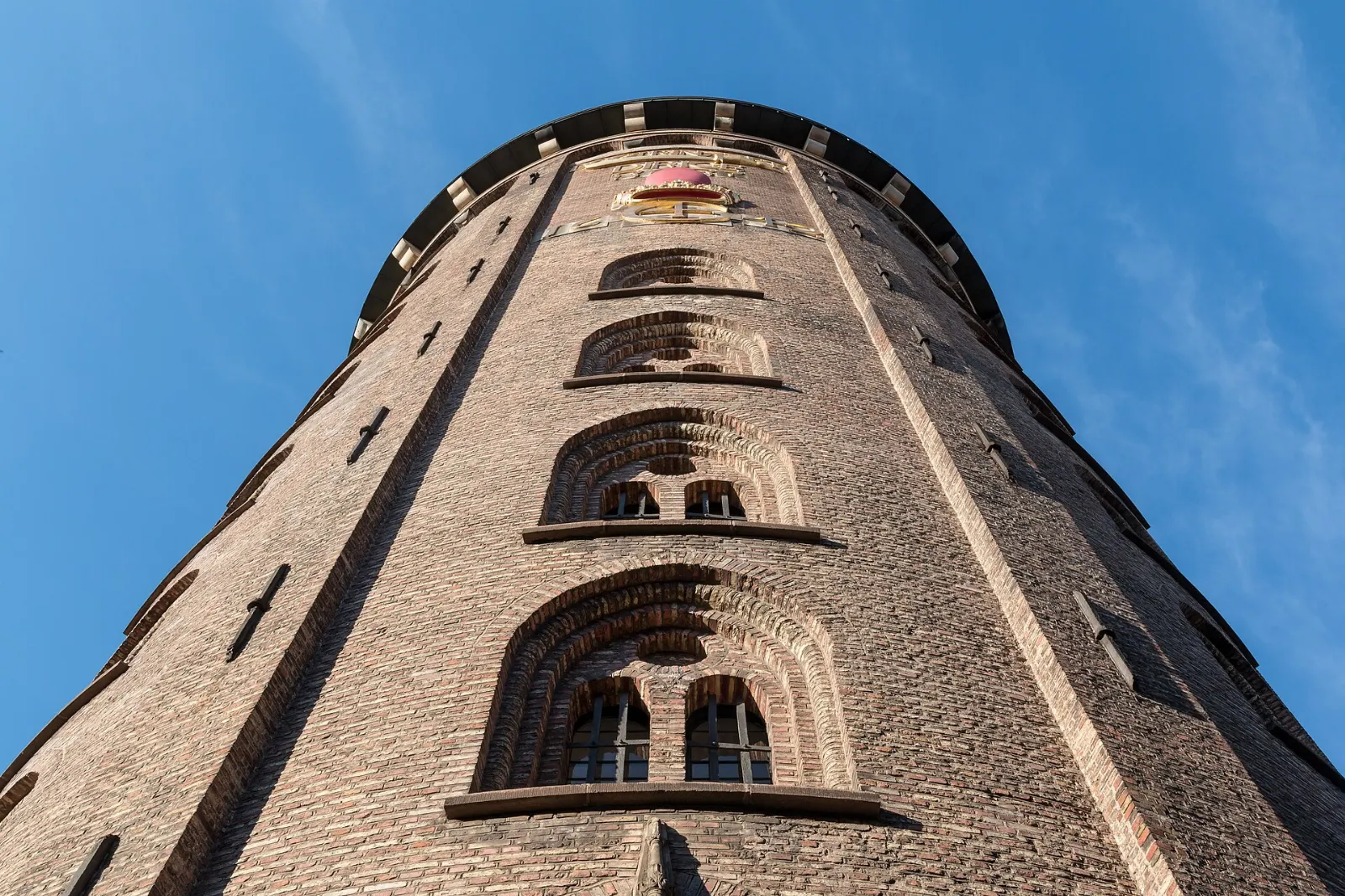 A round brick tower with a viewing platform on top above a city street, Copenhagen, Denmark