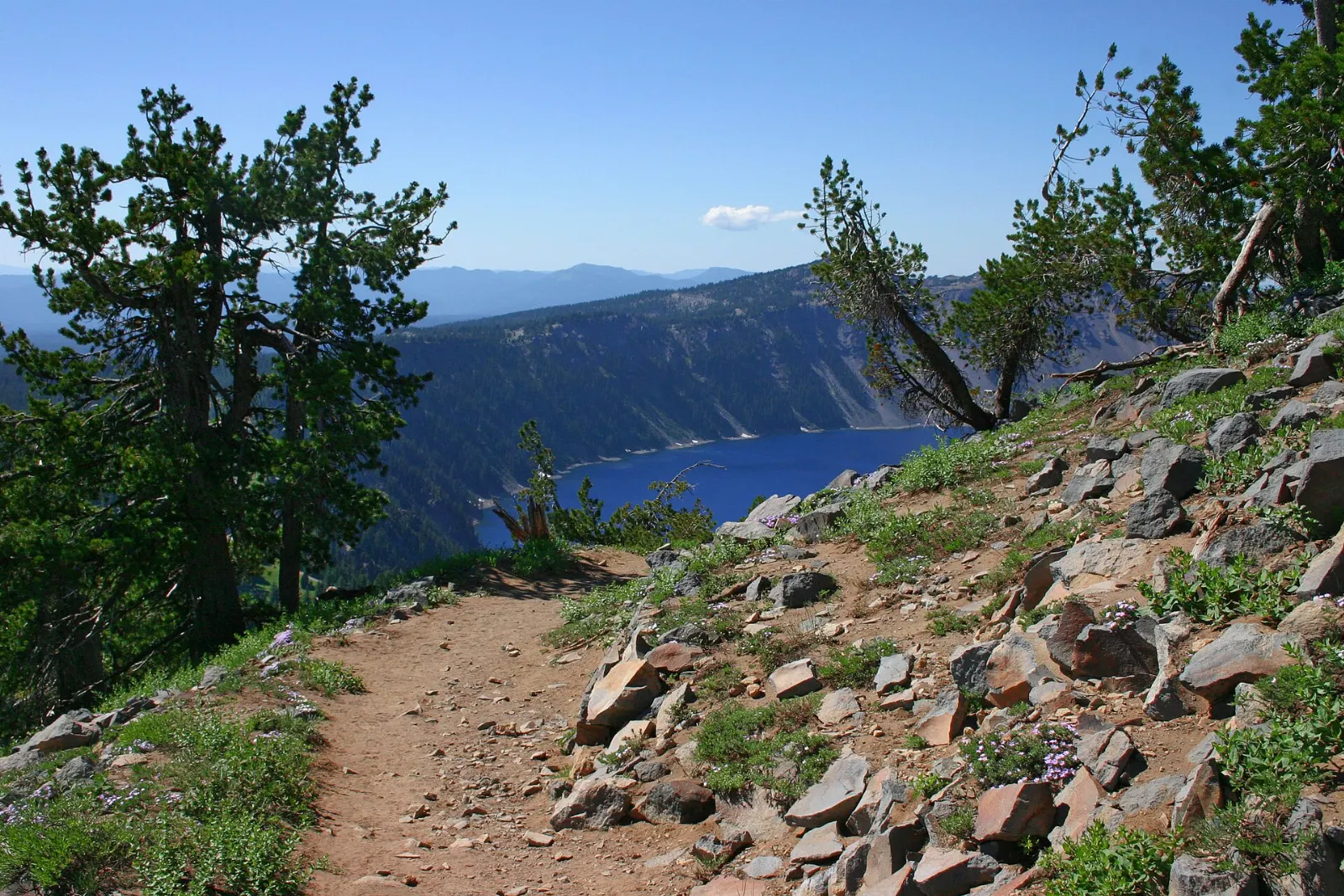 Rocky summit of Garfield Peak above the steep caldera walls and blue water, Crater Lake National Park, Oregon