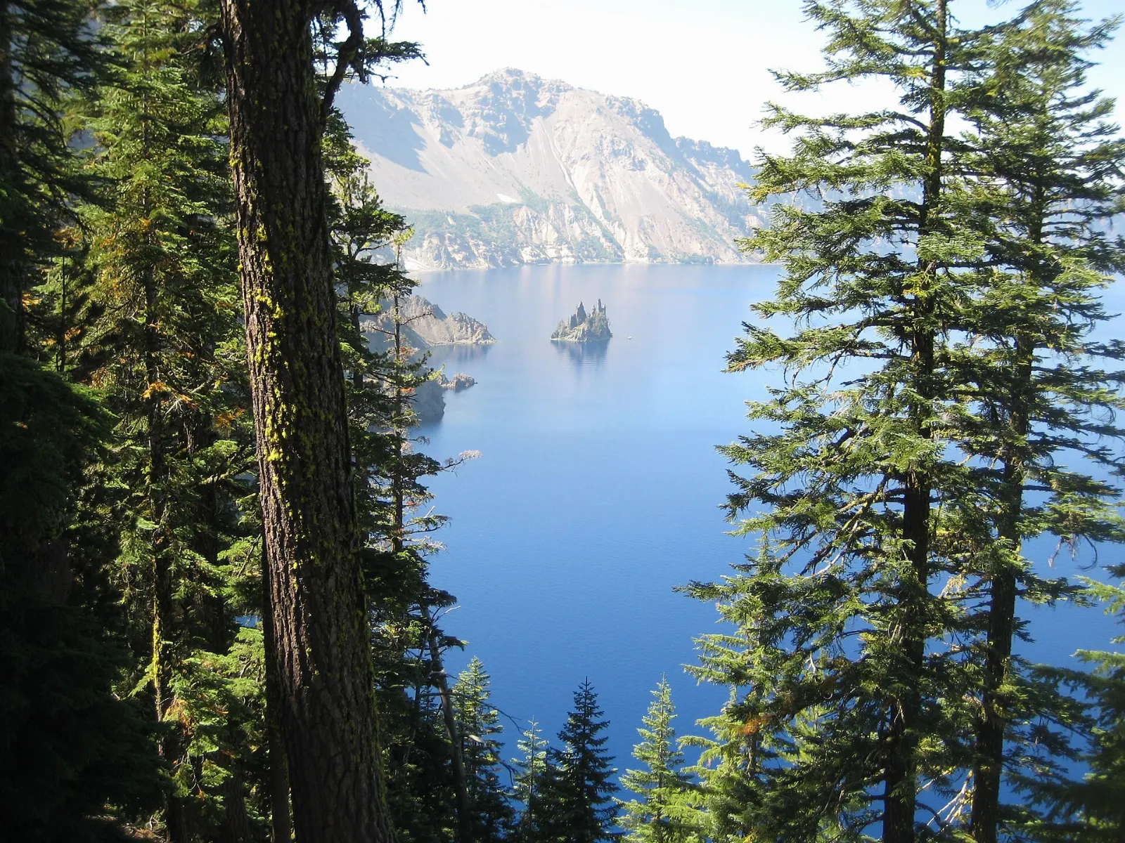 The jagged rocky islet called Phantom Ship on the dark blue surface of Crater Lake, Crater Lake National Park, Oregon
