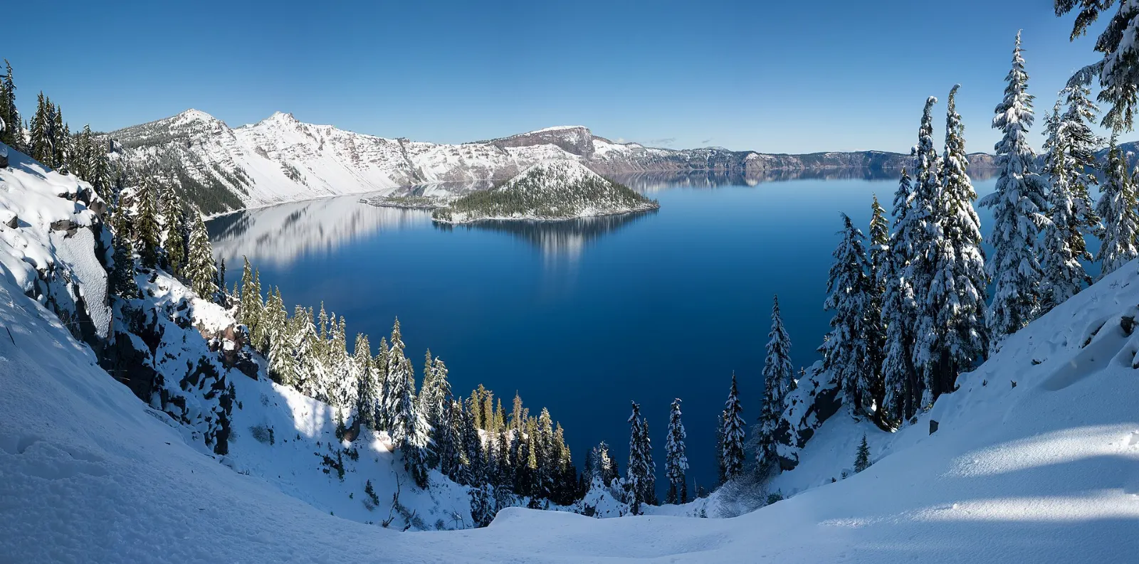 Crater Lake surrounded by deep snow on the caldera rim in winter, Crater Lake National Park, Oregon
