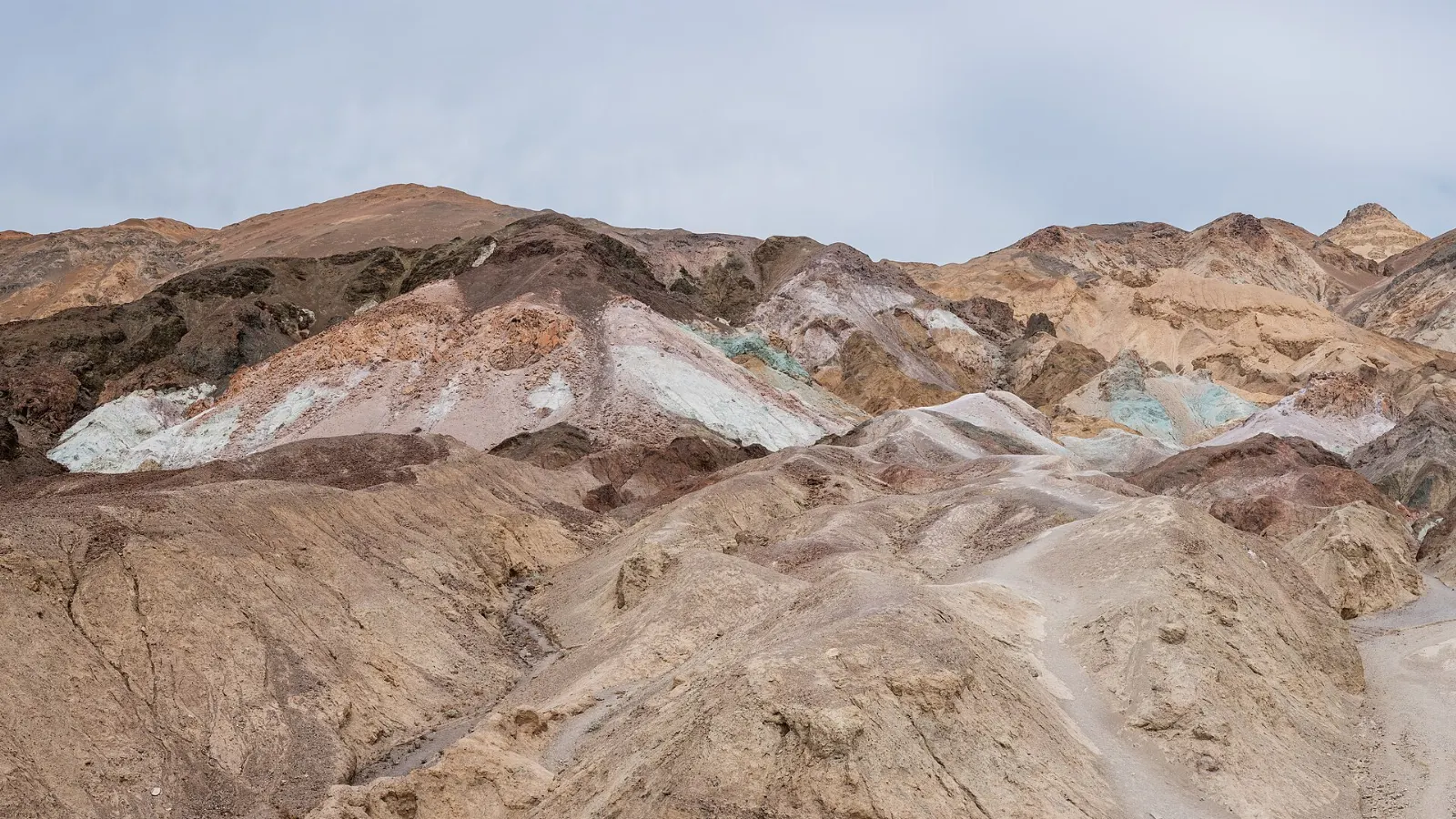Hillsides streaked with pink, green, purple and yellow mineral colors, Death Valley National Park, California