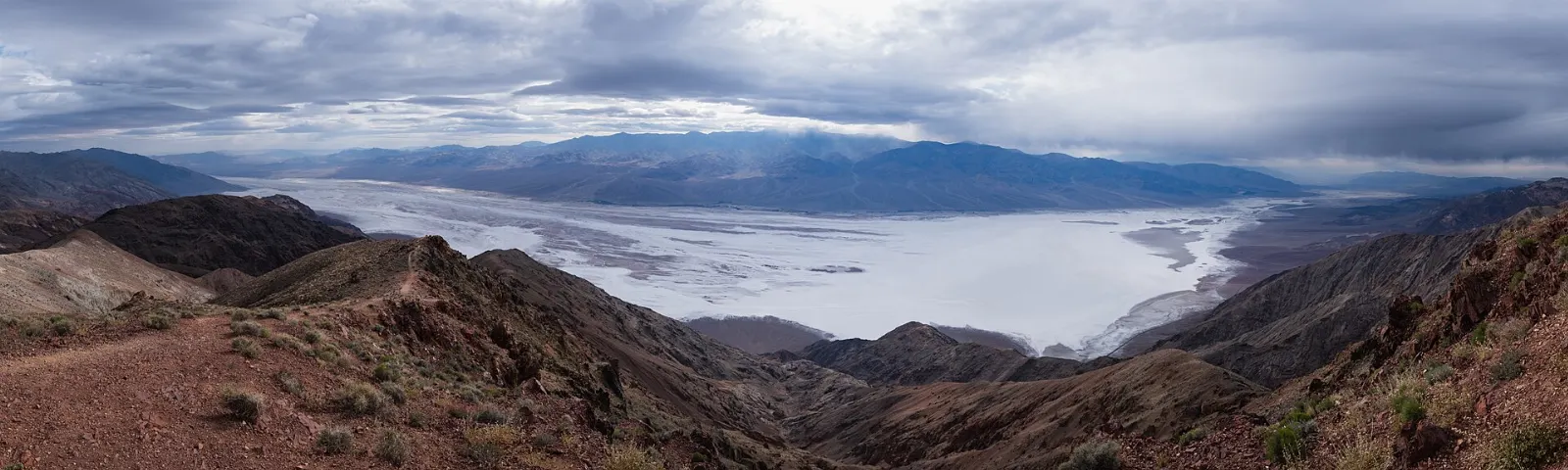 A high overlook above the white floor of Death Valley with snowy peaks beyond, Death Valley National Park, California