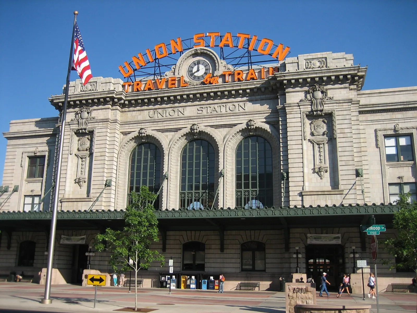 Historic Denver Union Station with its Travel by Train sign at dusk, Colorado
