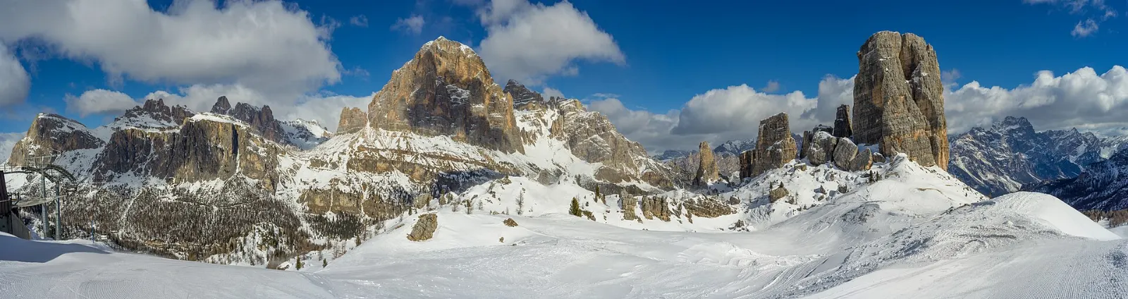 A cluster of pale gray rock towers on a high grassy shoulder, Dolomites, Italy