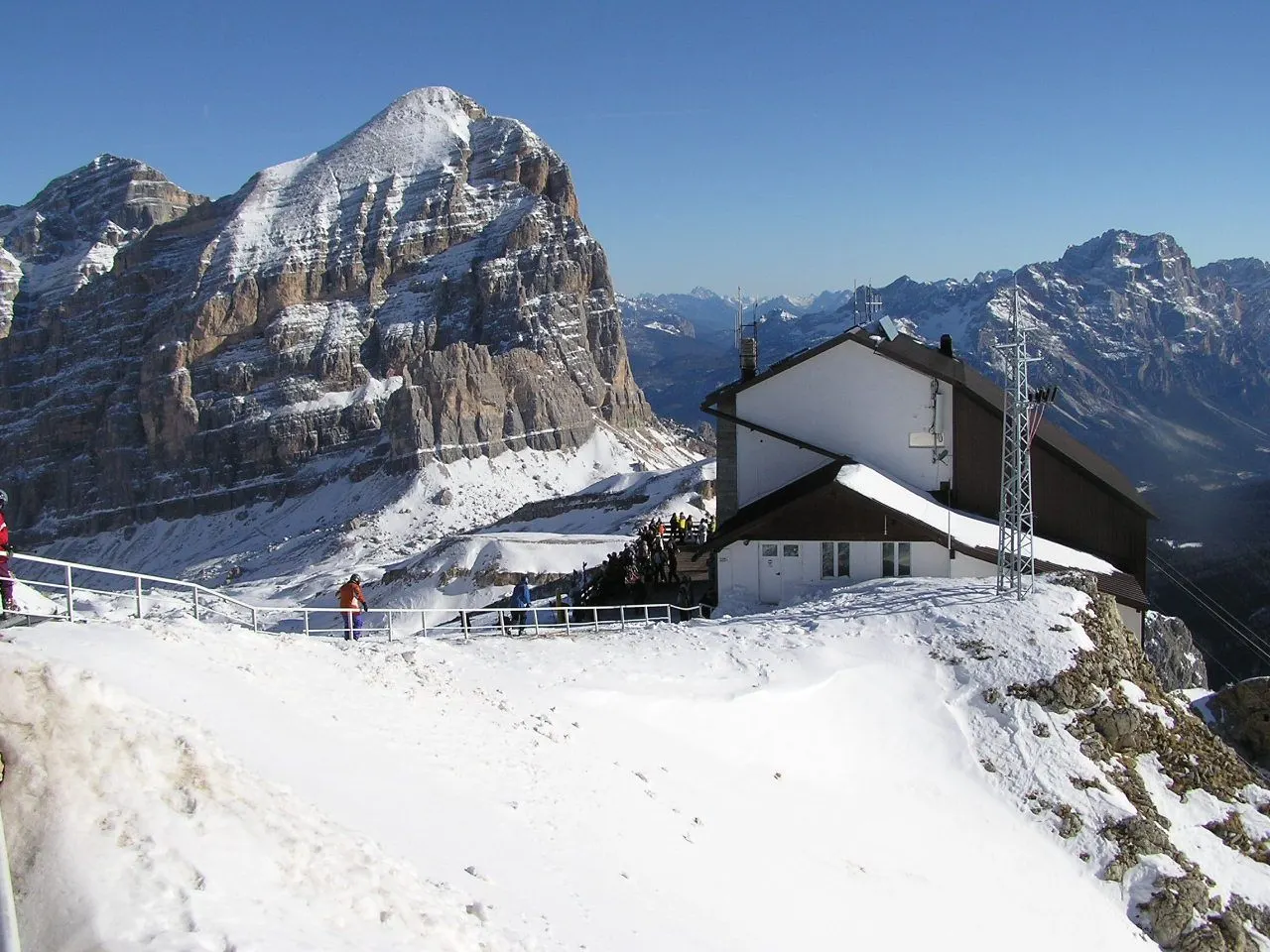 A mountain refuge perched on a high rocky summit above the clouds, Dolomites, Italy