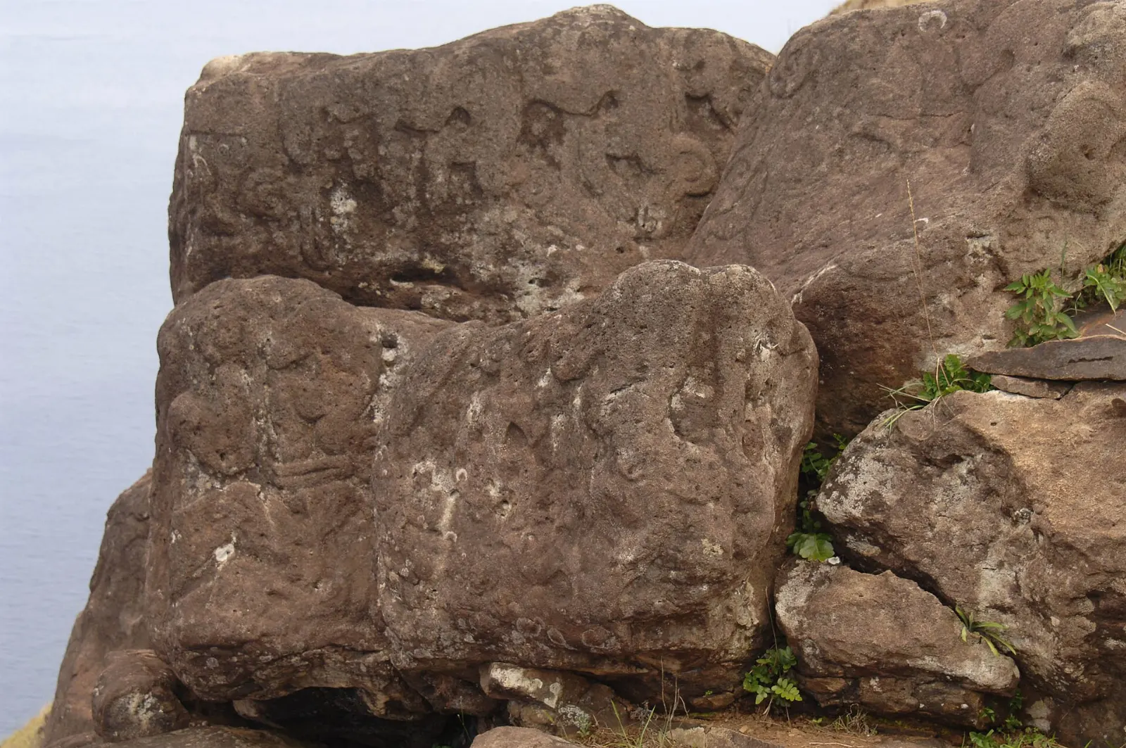 Birdman petroglyphs carved into basalt rocks at the Orongo ceremonial village, Easter Island, Chile