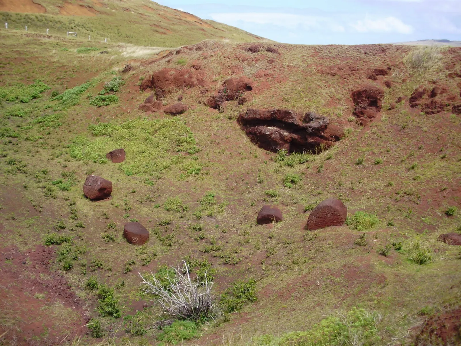 Red scoria topknots called pukao lying at the Puna Pau quarry, Easter Island, Chile