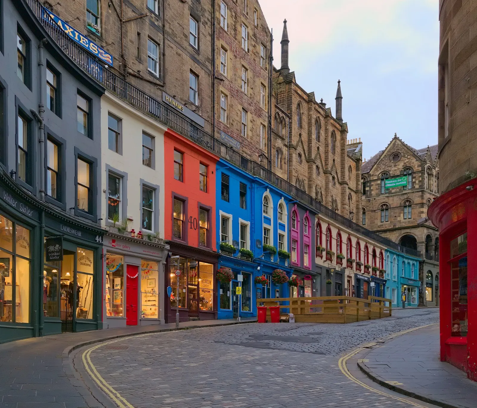 Curving Victoria Street lined with colorful shopfronts, Edinburgh, Scotland