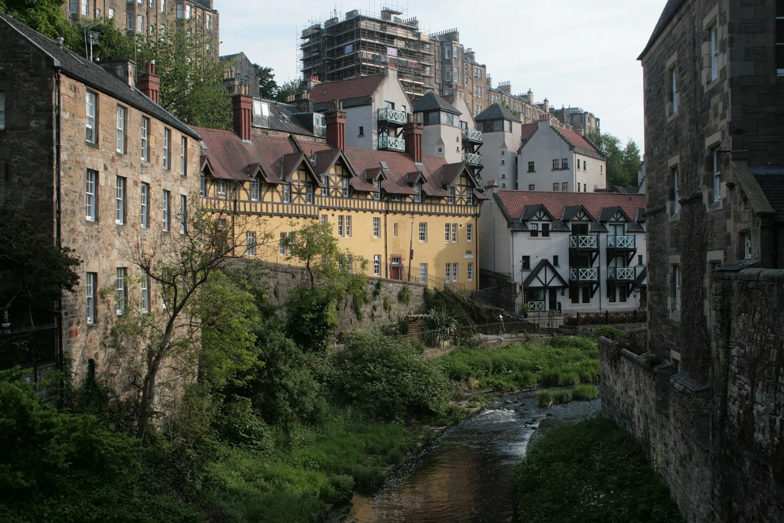 Old stone mill buildings beside the Water of Leith in Dean Village, Edinburgh, Scotland