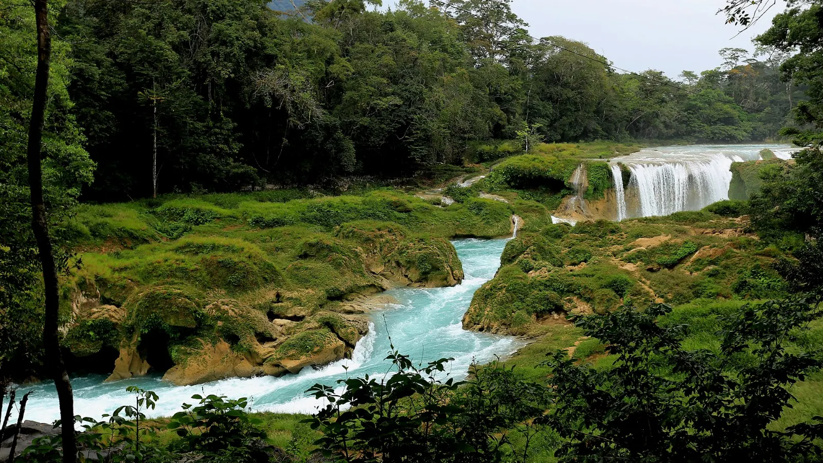Turquoise waterfalls with a footbridge at Las Nubes, El Chiflón Waterfalls, Chiapas