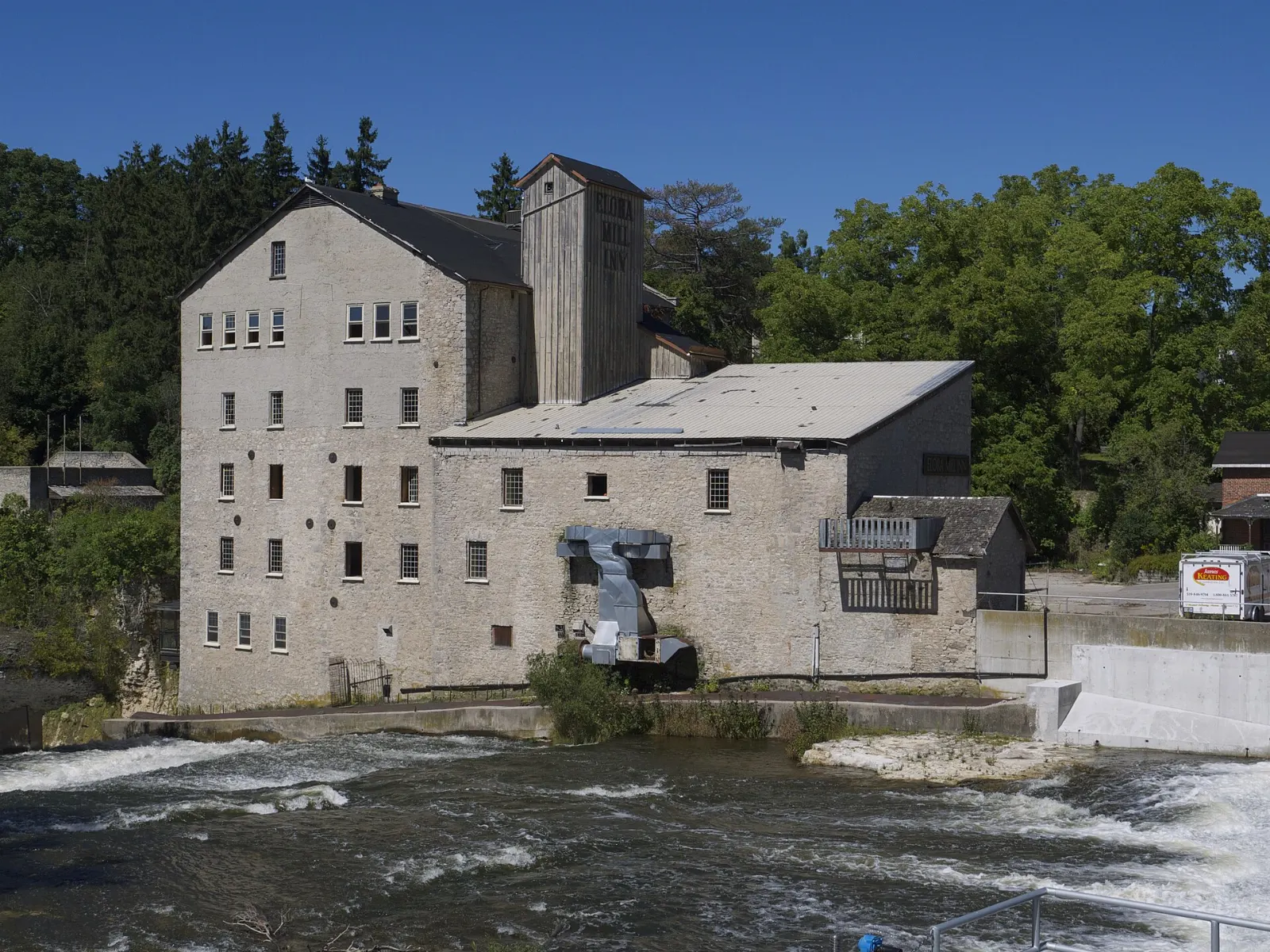 The five-storey stone Elora Mill above the Grand River, Ontario