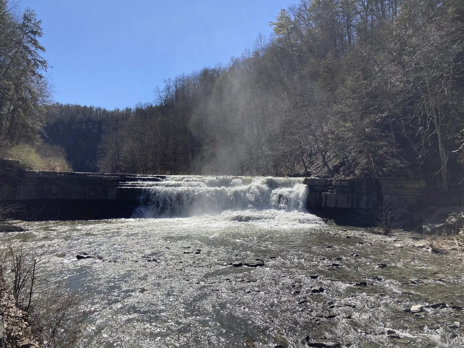 Taughannock Falls plunging into a deep amphitheater of layered rock cliffs, Finger Lakes, New York