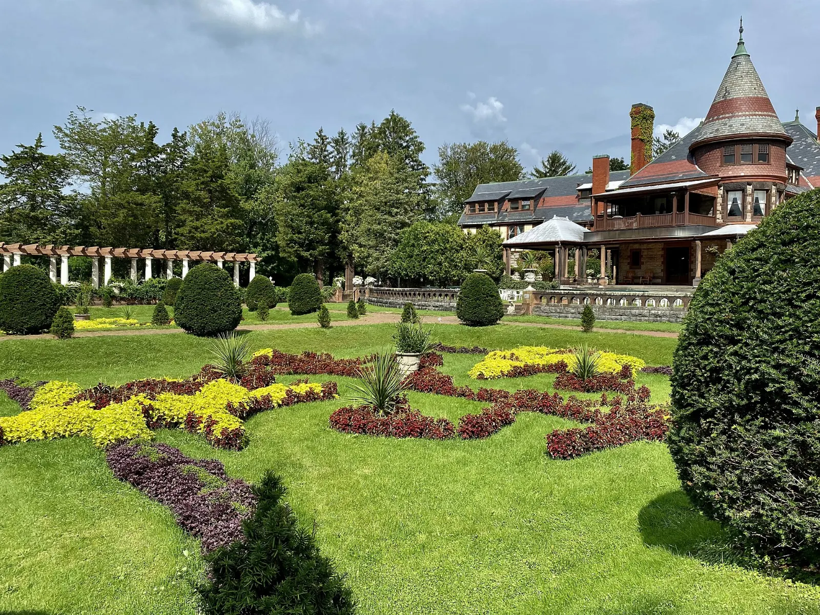 Formal flower beds in front of the stone Sonnenberg Mansion in Canandaigua, Finger Lakes, New York