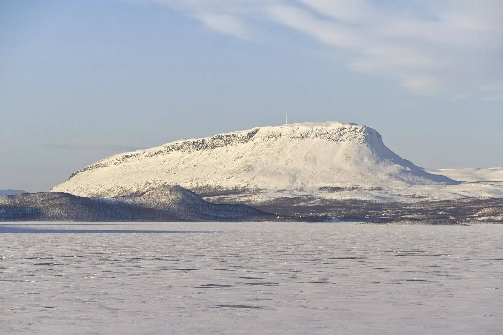 The steep, flat-topped Saana fell rising above a lake at Kilpisjärvi, Finnish Lapland, Finland